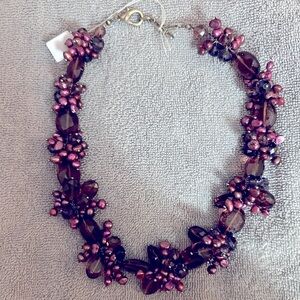 Beaded choker in shades of purple.